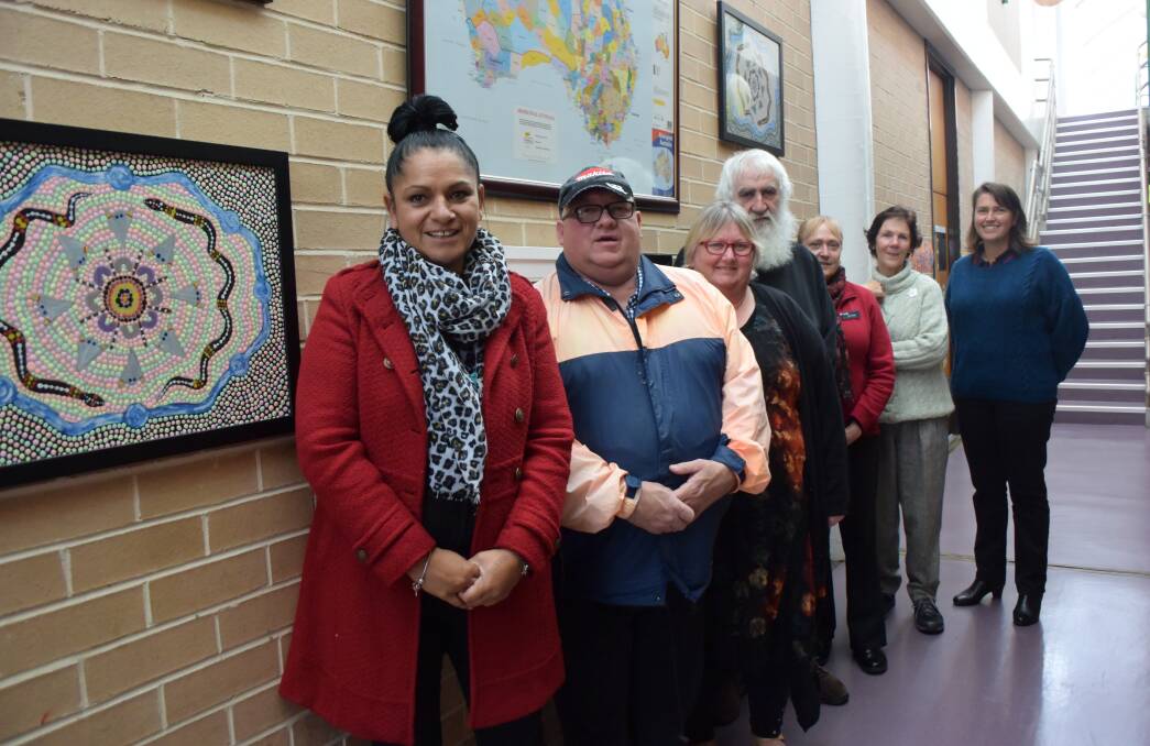 LITHGOW TAFE: Teachers and students celebrate Reconciliation Day on June 1 in front of some of the dot paintings produced by Lithgow TAFE student Jayson Horne. Pictured are Lisa Crawford, Danny Tulley, Karen Green, Allan, Jenny Brown, Christine McCormack and Alison Abbott. 