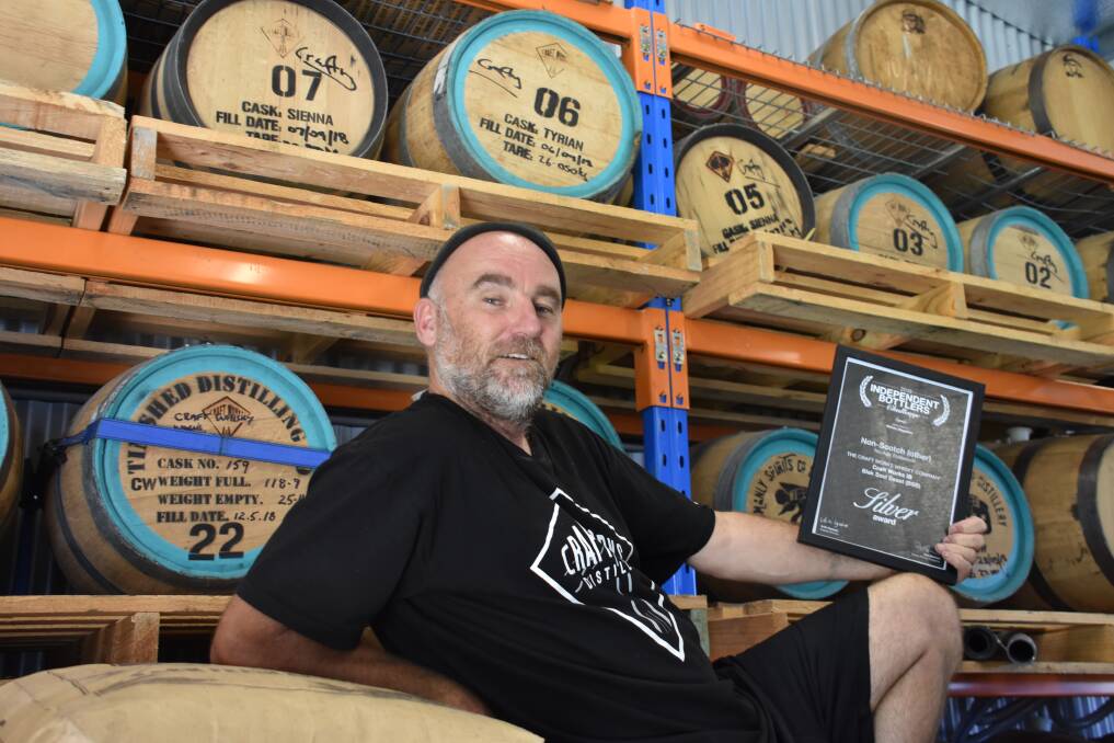 SILVER: Craft worker Craig 'Crafty' Field showing off his award in his micro-distillery in Capertee. Picture: ALANNA TOMAZIN.