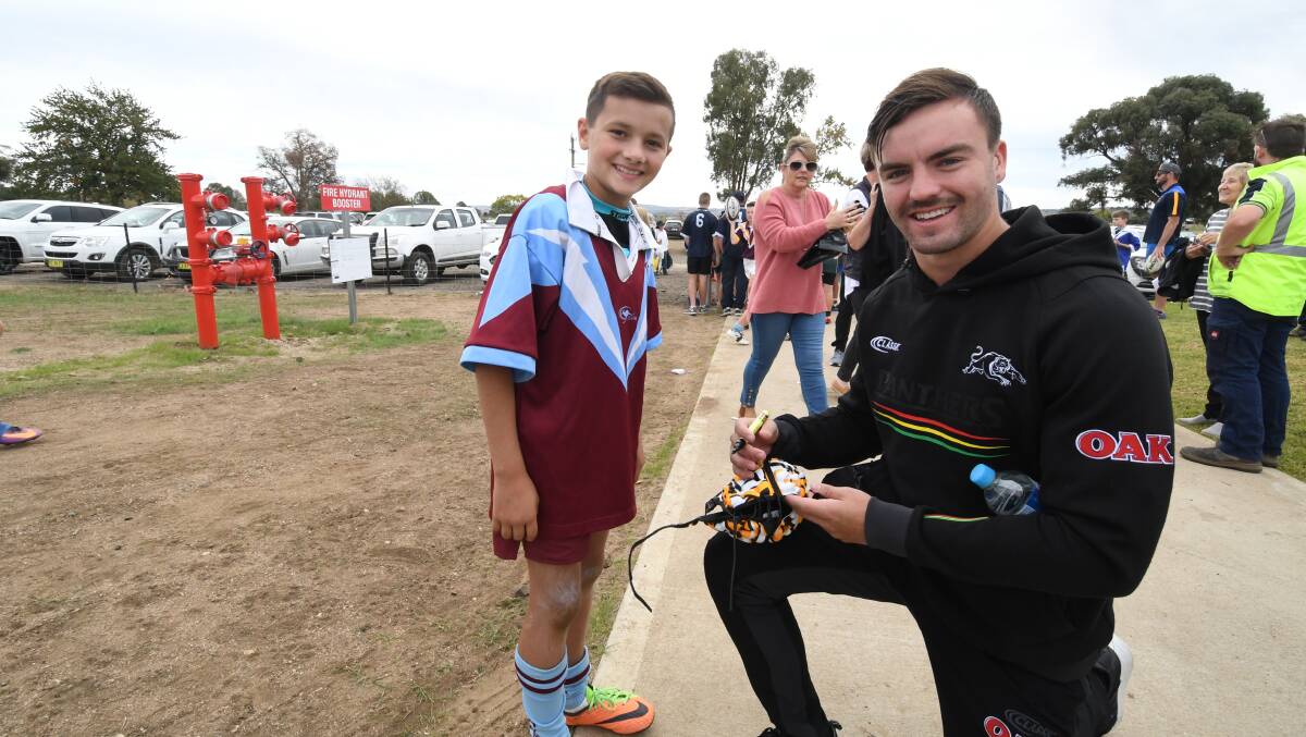 SIMILAR COLOUR, BUT NEW HOME: Lithgow's Wayde Egan with junior footy player Austin Hanrahan. Photo: CHRIS SEABROOK. 