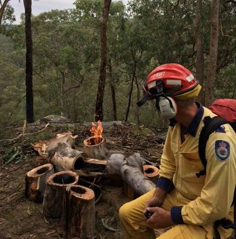 One of the hollowed-out logs on fire after overnight storms. Picture: CHIFLEY LITHGOW RFS. 