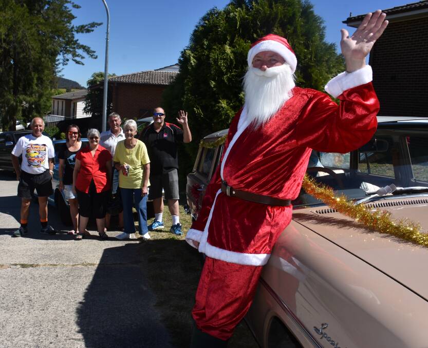 HI, SANTA! Santa and his helpers load up a convoy of cars as part of the annual toy run. Picture: KIRSTY HORTON. 