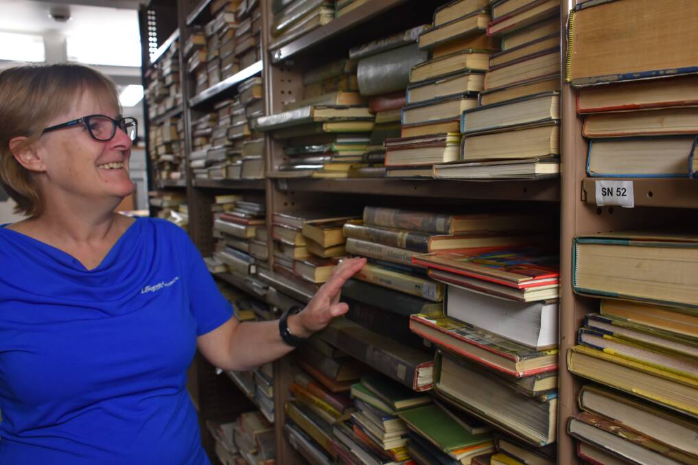 A MUCH-LOVED COLLECTION: Lithgow Library's acting coordinator Sharon Lewis with just some of the volumes. Picture: KIRSTY HORTON. 