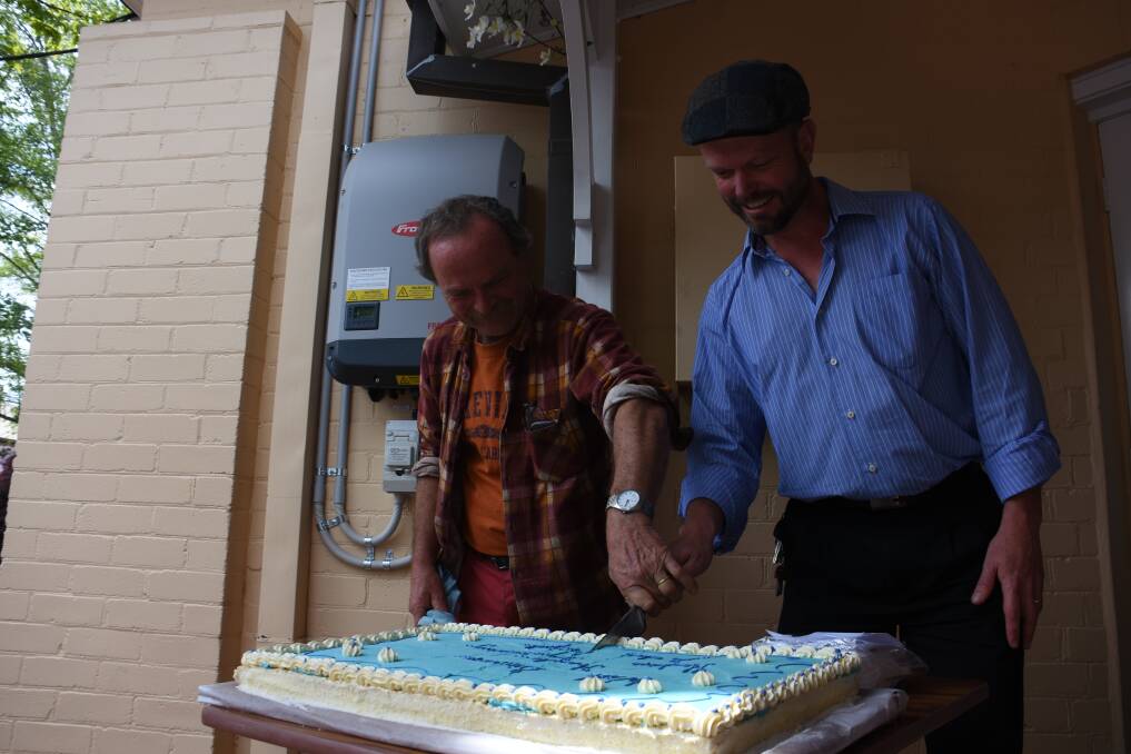 SOLAR POWER: Thomas Ebersoll and Rev Matthew Trounce with the cake marking the occasion. Pictures: KIRSTY HORTON. 