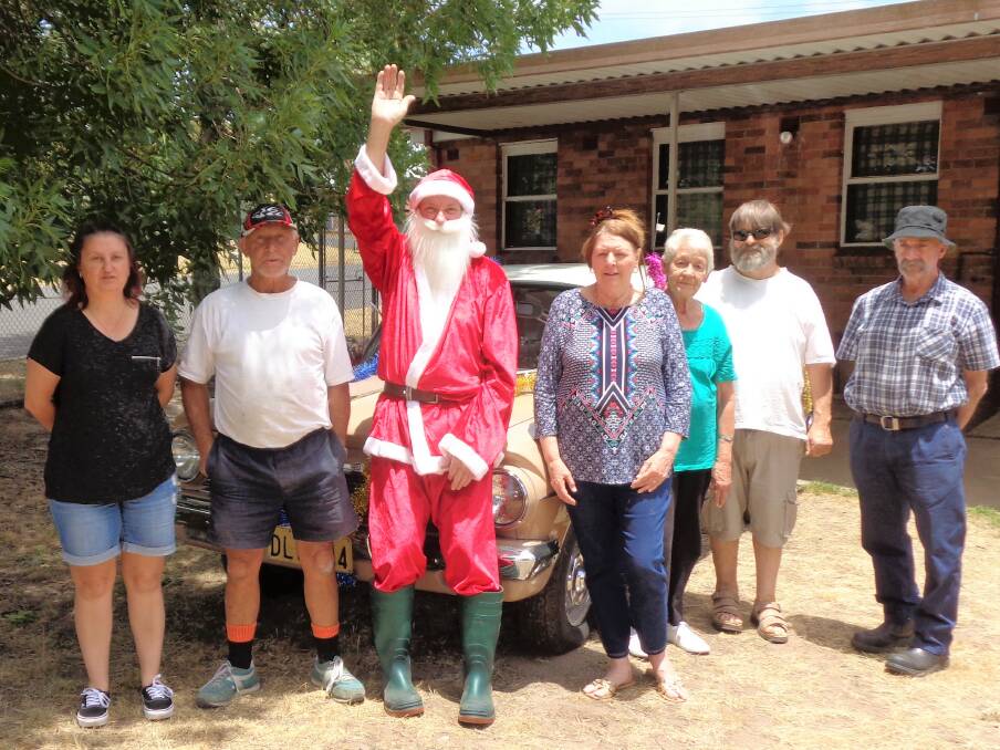 HO HO HO: Santa makes his deliveries with helpful elves Suzanne Yeo, Kevin McKinney, Cheryl Kylie, Lyn Ellery, Brian Kylie and Peter Lamb. Picture: Dave Martin