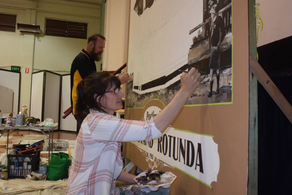 CREATING A MURAL: Peter Fishlock and Sharon Fensom at work on the mural for the band rotunda. Picture: KIRSTY HORTON. 