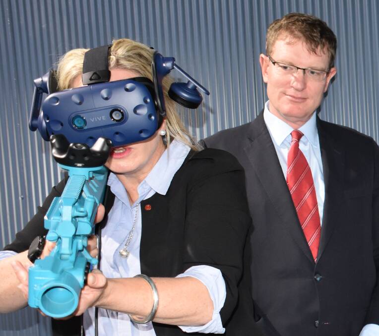 ARMED AND DANGEROUS: The Senator tries out some of the virtual reality tools installed in the innovation shed. 