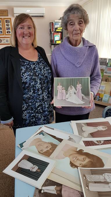 A GLIMPSE INTO THE PAST: Marie Mallett and Colleen Stack and some of the Roy and Eileen Pearce photos. Picture: SUPPLIED. 
