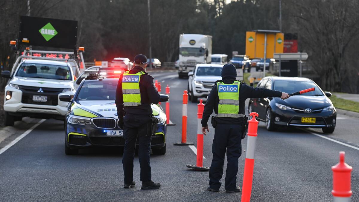 DILIGENCE: Checkpoints were set up on the Lincoln Causeway to check the licences or travel permits of people in cars with NSW licence plates. Picture: MARK JESSER 