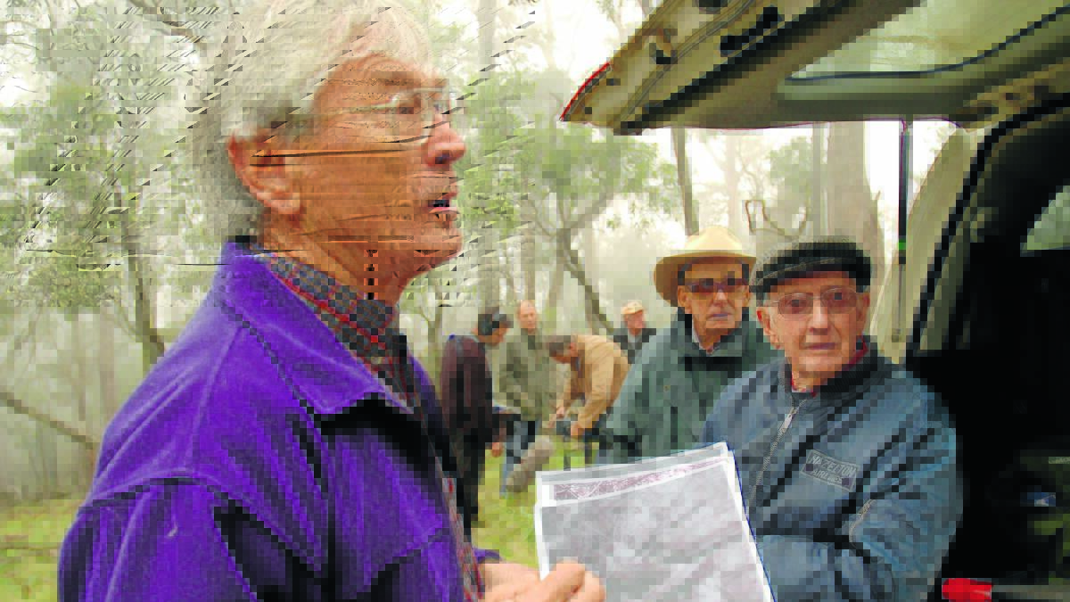 Dick Smith, Max Hazeltons brother-in-law Selwyn Murray and Max Hazelton use photos to pinpoint the crash site. Picture by Denis Gregory.
