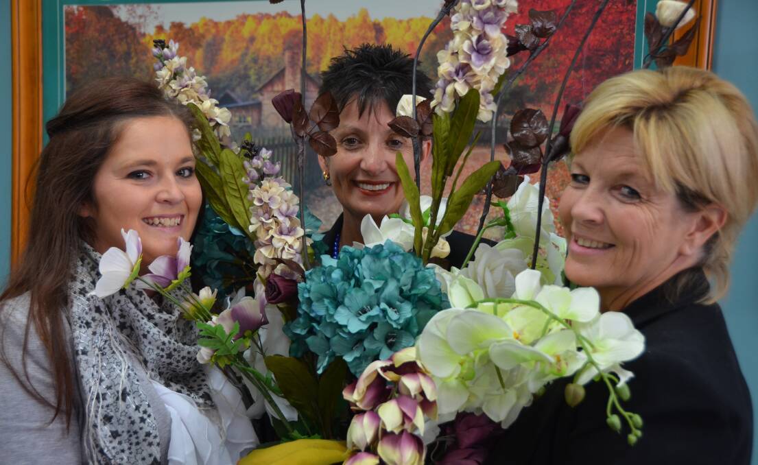 LITHGOW MERCURY staff members Angie Cambourne, Carmel Houlison and Mandy Wright prepare the Mercury Office for participation in
the mid town walk of the flowers.
