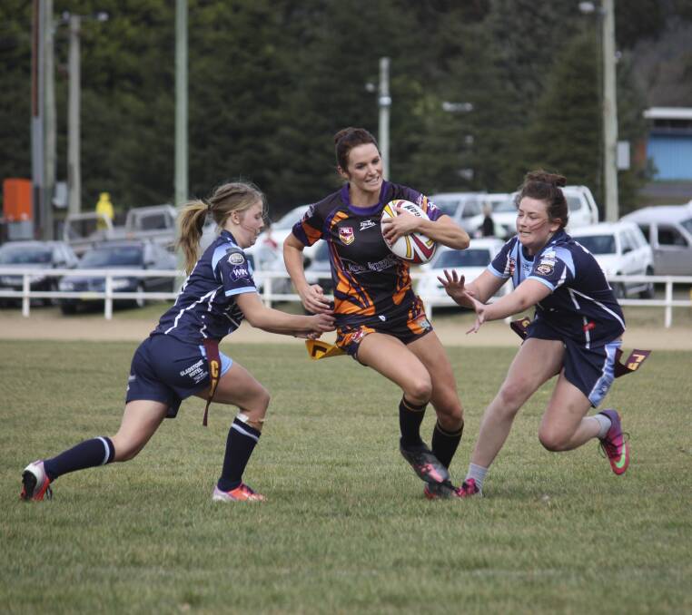 Oz League's Chrissie West splits the defence on her way to one of her three tries 