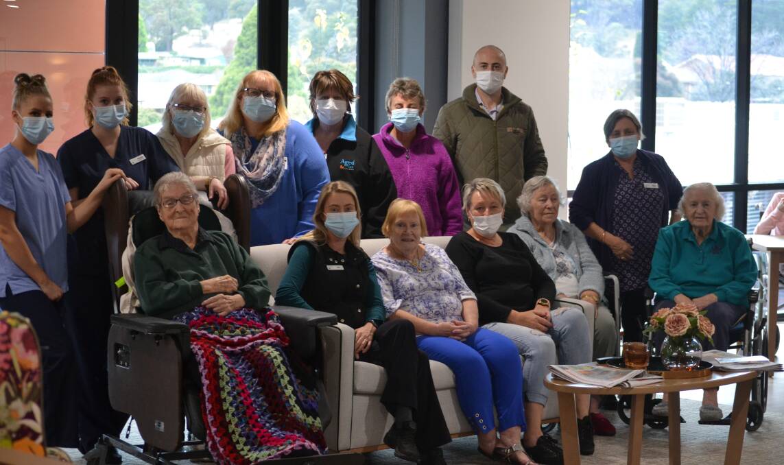 SMILES BEHIND THE MASKS: Respect Aged Care staff and residents at the centre on Thursday. Photo: Ciara Bastow