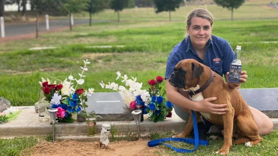 HEARTACHE: Maddie Bott visits Ethan's grave with dog Knox on what was meant to be their wedding day.