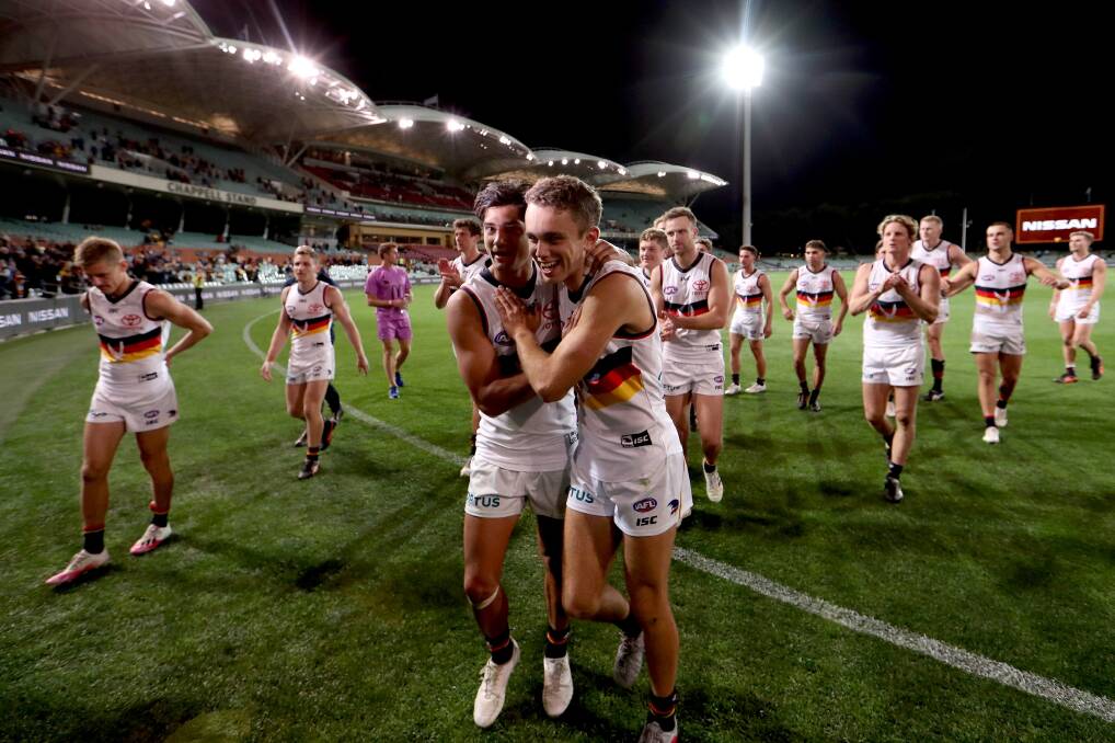 Crows' Shane McAdam and Lachlan Sholl celebrate the club's first win of the 2020 season. Photo: James Elsby/AFL Photos via Getty Images