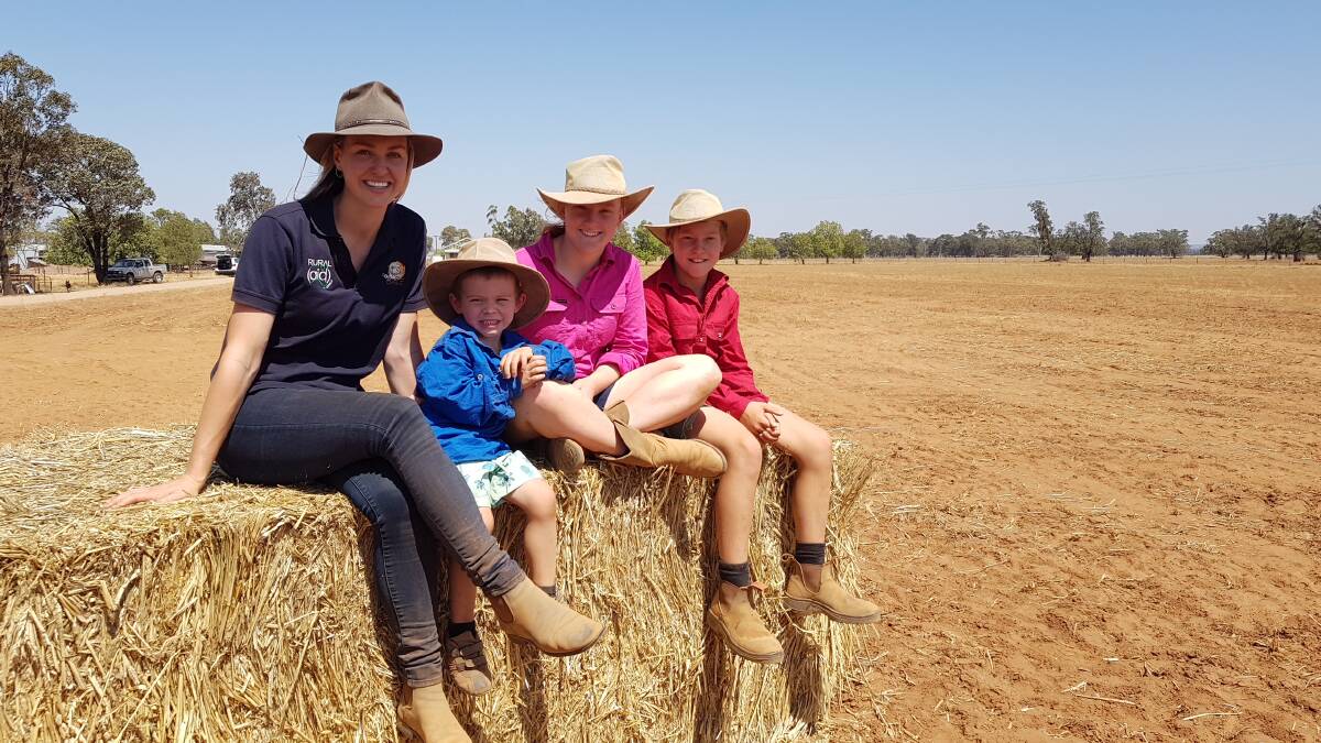HERE TO HELP: Rural Aid registered counsellor Zoe Cox with Mitchell, 4, Emily, 15, and Brodie, 13, Gartner from Bogan Gate. She has been providing support to the Gartner family for a period of time. Photo: SUPPLIED 021119zoe3