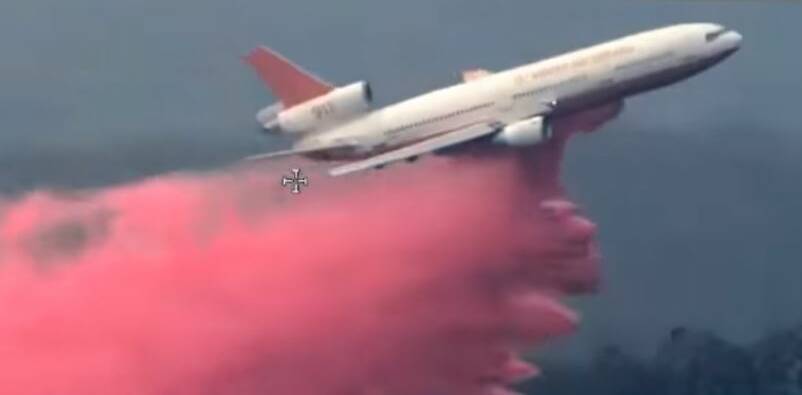BLAZE: An aircraft dropping retardant on the massive Gospers Mountain bushfire on Monday afternoon. Photo: NSW RFS
