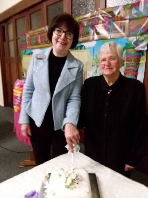 CELEBRATE: Jeanette Craddock and Sue Holt are ready to cut the cake.