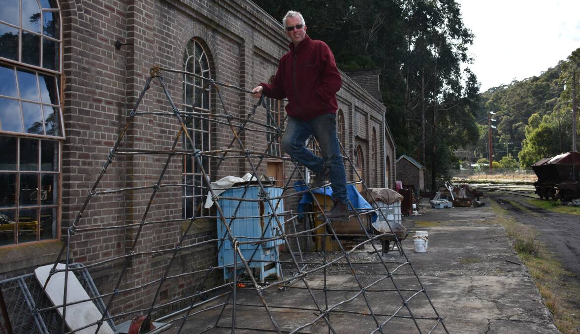 LITHGOW TALENT: Metal worker Philip Spark climbs on one of his new structures to be featured at Sydney Zoo. Picture: ALANNA TOMAZIN.