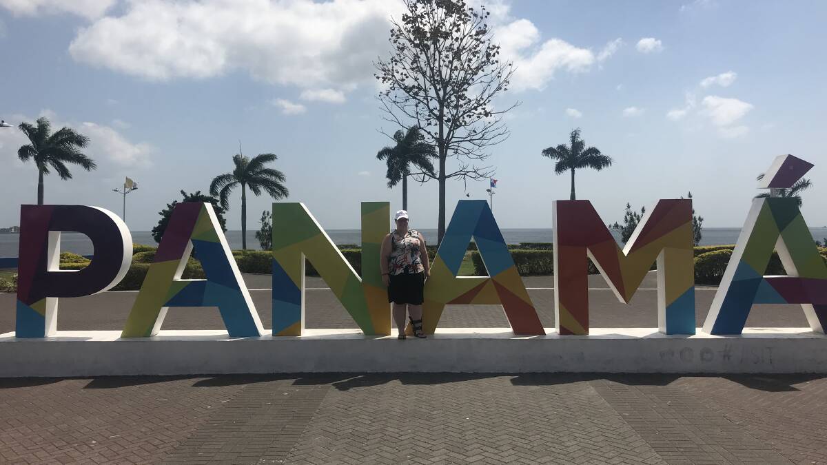 PILGRIM IN PANAMA: Youth minister Emily Bennett in front of the Panama sign along the foreshore just outside of Panama City. Picture: SUPPLIED.