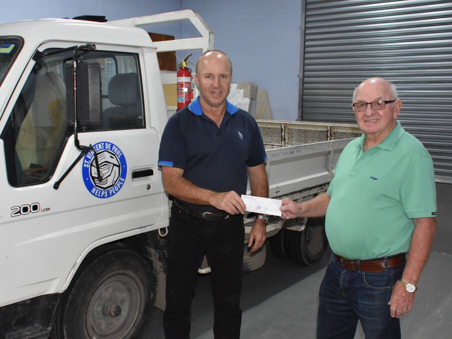 GENEROUS: Clarence Colliery mine manager Kyle Egan hands over the cheque to Vinnies Lithgow president Gary Marshall. Picture: ALANNA TOMAZIN.