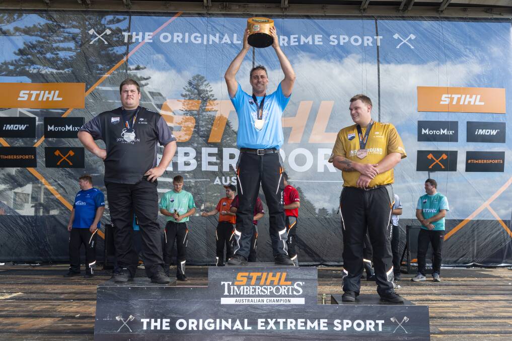 VICTORIOUS: Lithgow's Brad De Losa (middle) holds up the 2022 Stihl Timbersports Australian Trophy at Glenelg Beach, South Australia. Picture: SUPPLIED