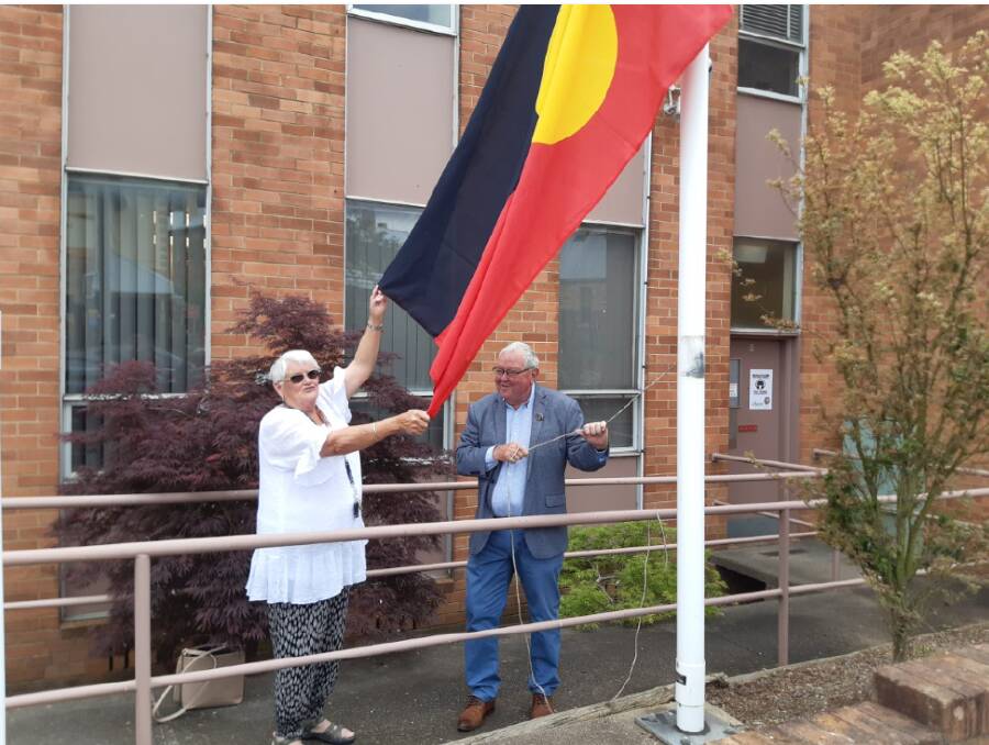 NAIDOC 2020: Mingaan Wiradjuri Aboriginal Corporation's Aunty Helen Riley and Lithgow City mayor Cr Ray Thompson raise the flag outside the chambers. Photo: SUPPLIED.