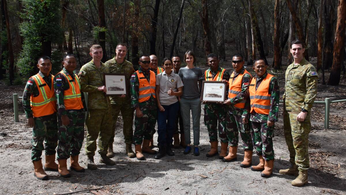 WORKING TOGETHER: ADF and IDF corporals accept their certificate of appreciation from Mingaan Wiradjuri Aboriginal Corporation at The Hands. Picture: ALANNA TOMAZIN.