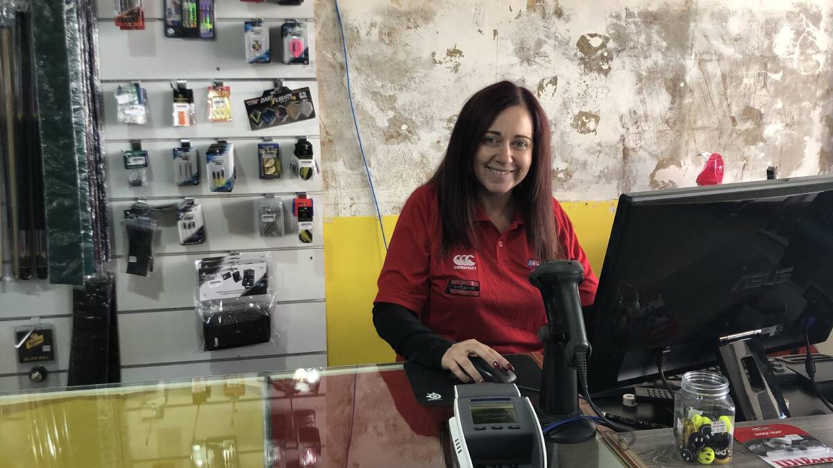 JOB SWAP: Clever clippers owner Sally Collins tries her hand at retail at Sportspower Lithgow. Picture: SUPPLIED.