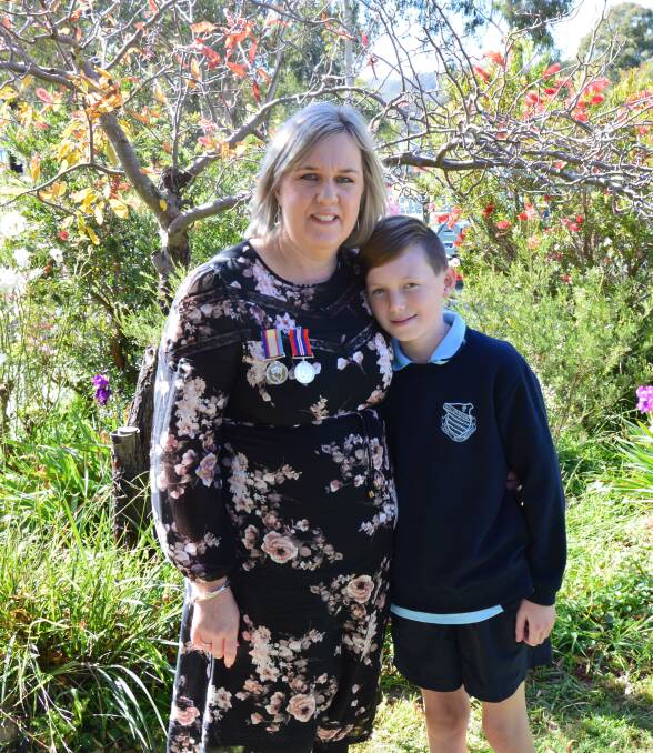 FAMILY TREASURE: Wallerawang Public School principal Jenny Lamborn with her son James, wearing her fathers war medals. Photo: ALANNA TOMAZIN.