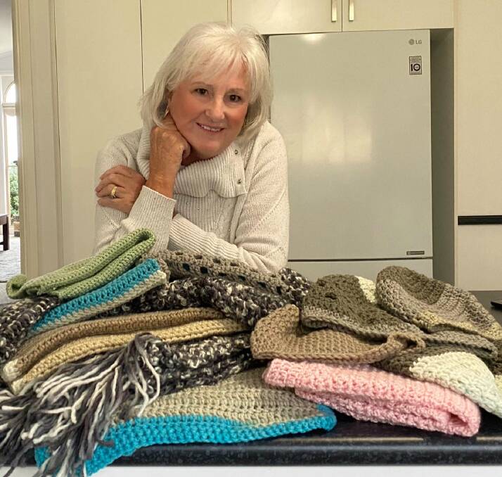 KINDNESS: Dawn Douglas with her completed beanies and scarves ready to donate to the homeless. Picture: SUPPLIED.
