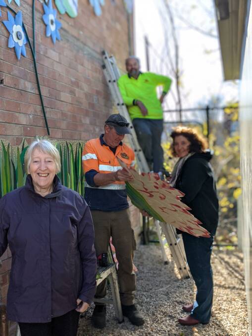 INSTALLATION: Lithgow Tidy Towns and local artists help to install the new work. Photo: SUPPLIED
