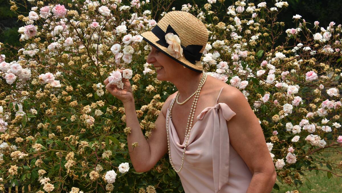 A FRESH START: Vicki smells the lovely roses in her 1920s outfit. Picture: ALANNA TOMAZIN.
