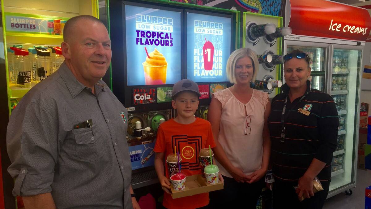 SUMMER SLURPEES: 7-Eleven store manager Barry King with customers Lachlan and Monesha and staff member Wendy. Picture: ALANNA TOMAZIN.