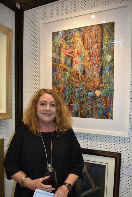 LOCAL TALENT: Artist Jenny Sewell with one of her artworks pictured behind. Picture: ALANNA TOMAZIN.
