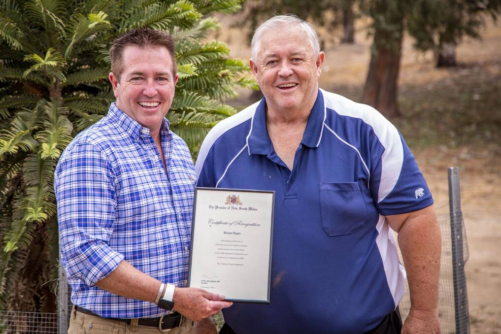 RECOGNITION: Bathurst MP Paul Toole presents Bruce Ryan with his certificate of recognition. Picture: SUPPLIED.