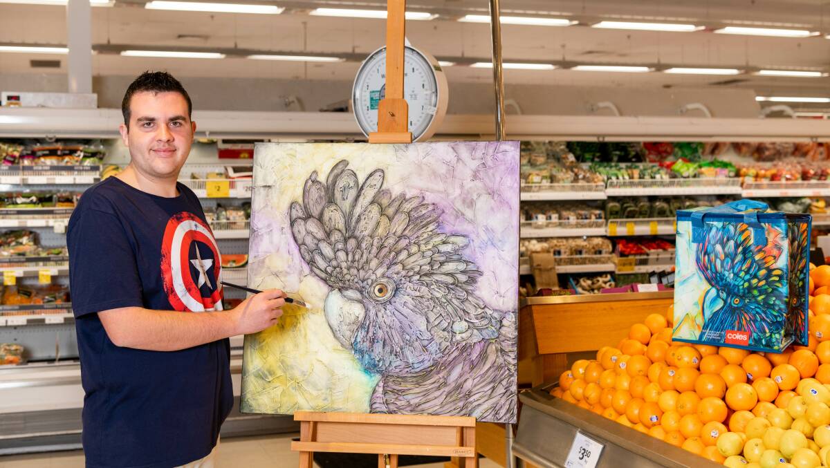 YOUNG ARTIST: Will Hazzard with his original yellow-tail black cockatoo artwork and Coles bag design. Photo: SUPPLIED.