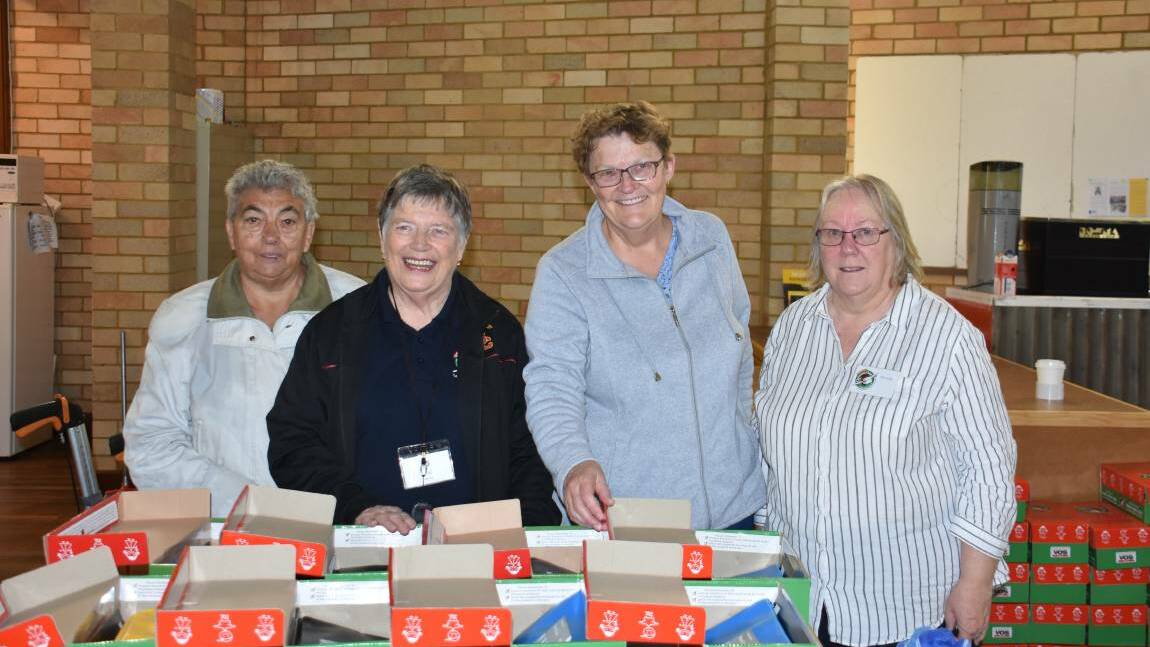 HELPING HAND: Volunteers Gwen Collins, Val Morris, Anne McLennan and Janice Howarth pack shoe boxes for those in need. Photo: ALANNA TOMAZIN.