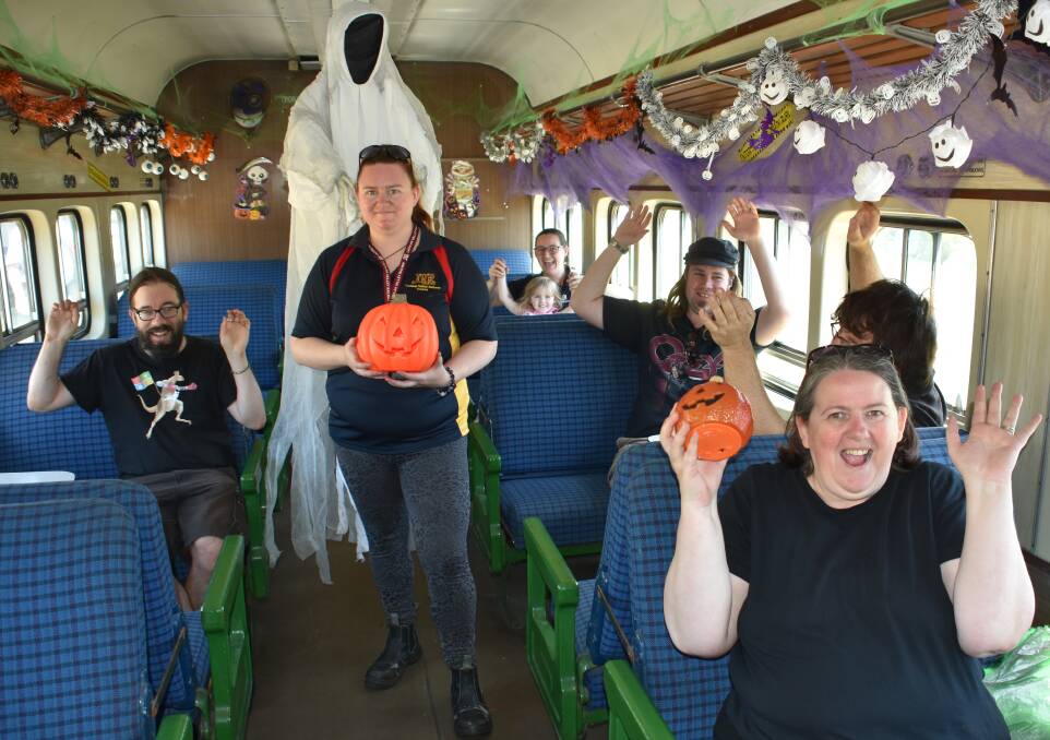 SPOOKY RIDE: The volunteer decorators preparing the party car for Lithgow Halloween. Picture: ALANNA TOMAZIN.