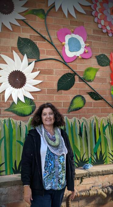 VIBRANT ARTWORK: Lithgow artist Ludwina Roebuck with her colourful artwork in Pioneer Heritage Park. Photo: SUPPLIED