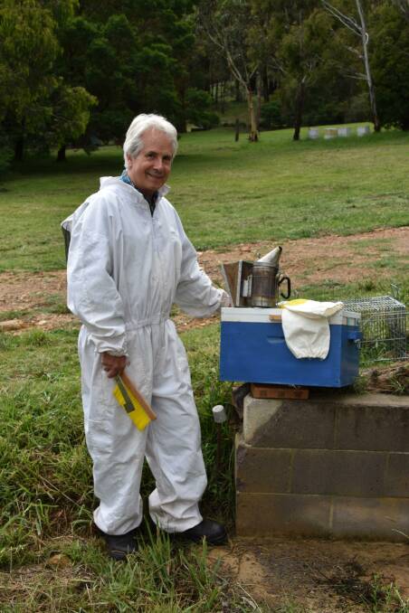 AMATEUR BEEKEEPER: Adrian Leighton wears his beekeeper's suit and shows off his tools in Little Hartley. Picture: ALANNA TOMAZIN.