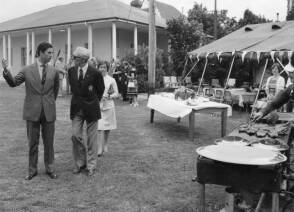 Prince Charles, Bill and Joanna Mantle closely behind 6 November 1977 at Lancer Barracks Parramatta, with barbeque ready.