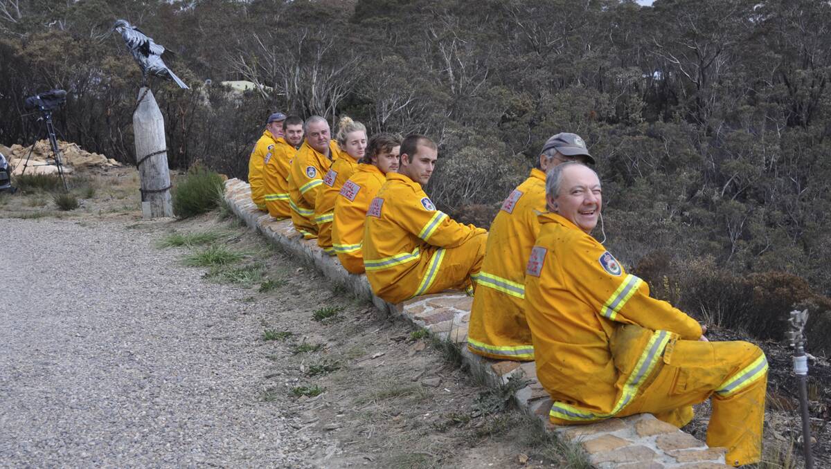 A MOMENT OF PEACE: the Mid Lachlan Valley RFS Team during the October bushfires. Photo: Carolyn Piggott