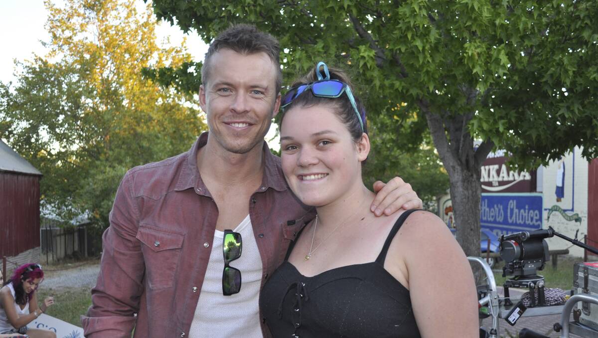 FAN: Lucky local girl Mollie Briggs gets a pic and an autograph from one of the actors, Todd Lasance (Home and Away, Underbelly, Sparticus — War of the Damned). 	lm011514terminus