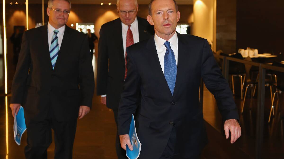 Opposition Leader Tony Abbott Leaves the media conference after unveiling the Coalition Border Protection Policy with Shadow Minister for Immigration Scott Morrison and retired Australian Army Major-General, Jim Molan at the Hilton Hotel on July 25, in Brisbane. Photo by Chris Hyde/Getty Images.