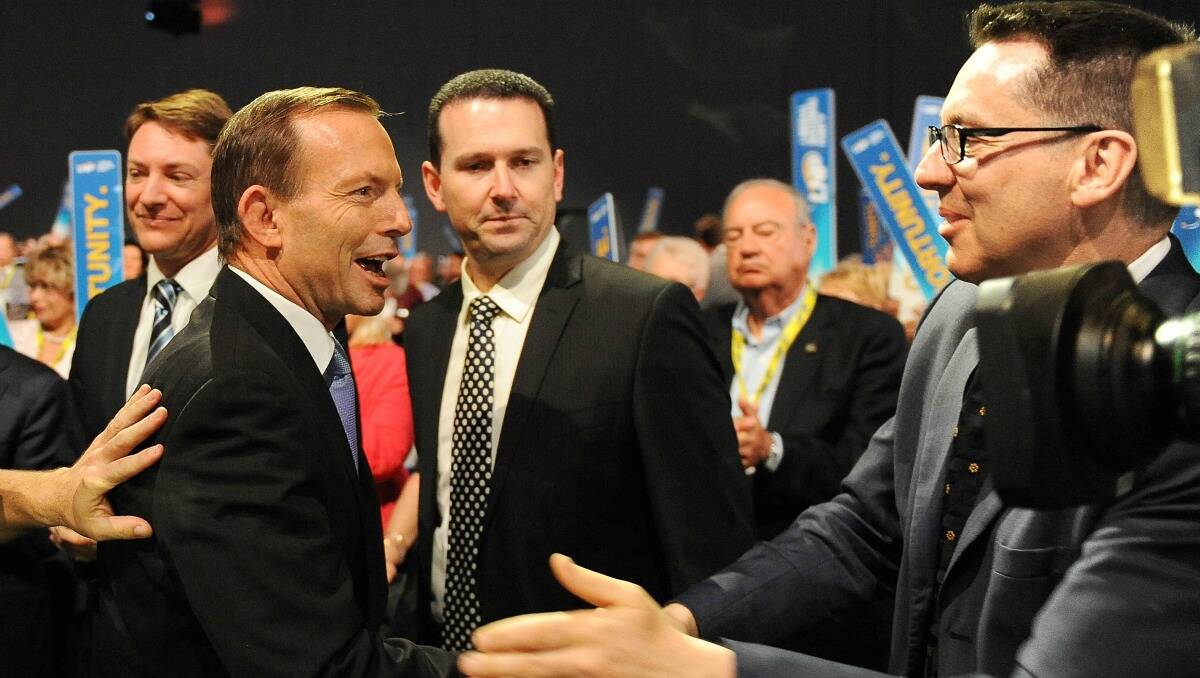 Opposition Leader Tony Abbott shakes hands with delegates during an LNP State Convention at the Royal International Centre on July 20,  in Brisbane, Australia. Photo by Matt Roberts/Getty Image