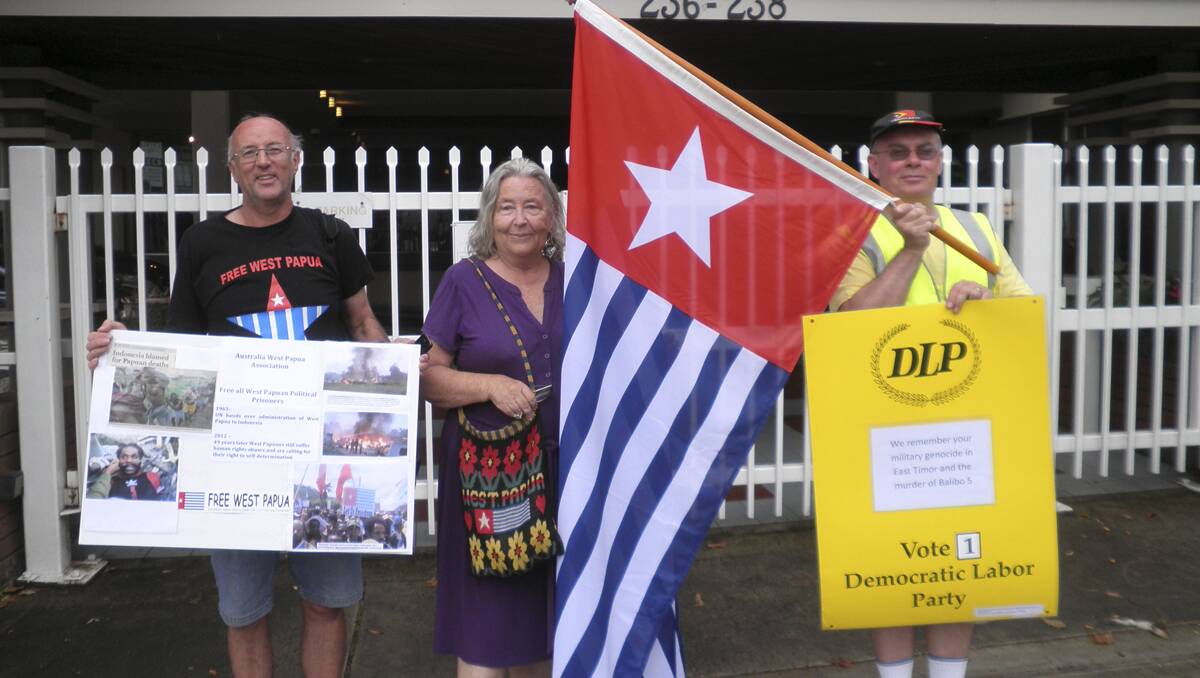 THE MORNING STAR FLAG: Anthony Craig holds the flag with Ann and Joe Noonan from the Australian West Papua Association in front of the Indonesian consulate in Sydney 	
